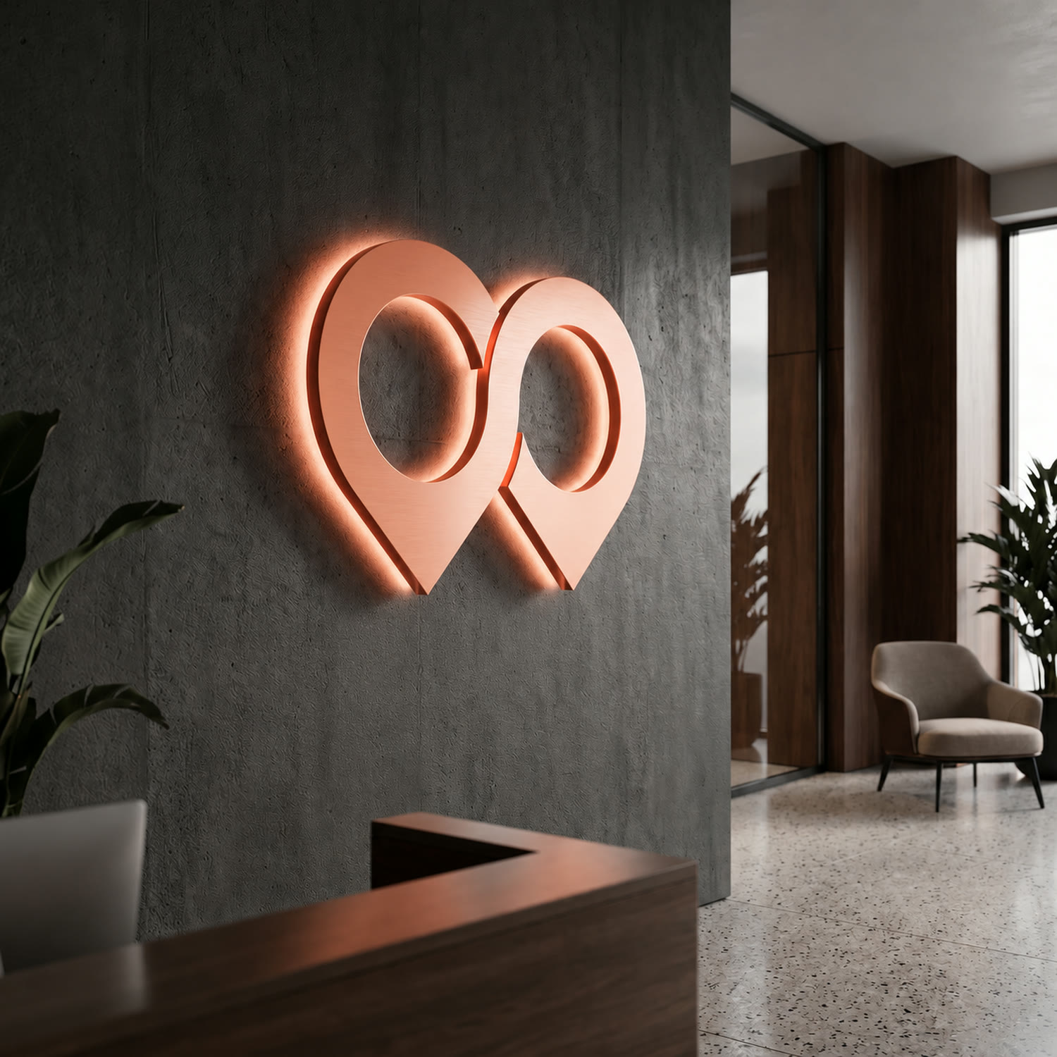 The HoodLens mark backlit in coral on a dark concrete wall in a reception area.
