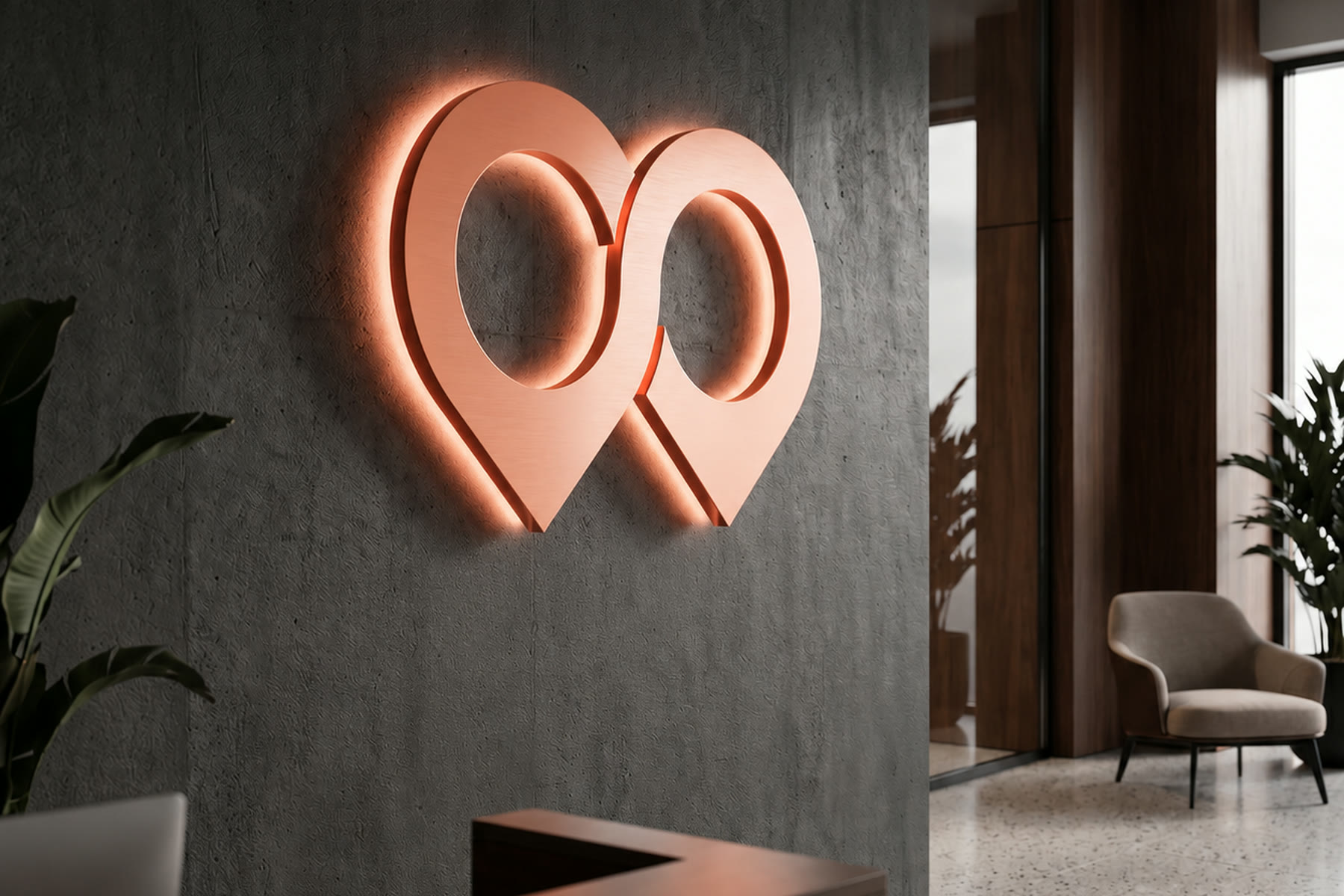 The HoodLens mark, two location pins fused into a pair of binoculars, backlit in coral on a dark concrete reception wall.